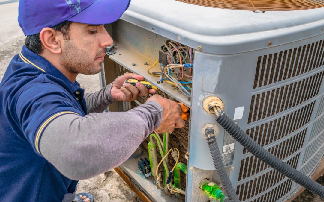 Carini technician repairing AC in San Diego home