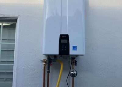 tankless water heater installed on a wall outside